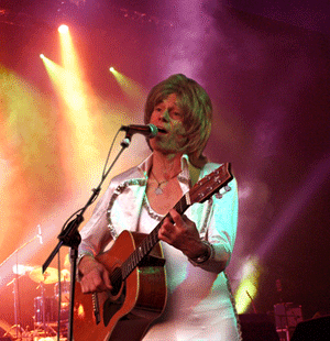 ABBA tribute act PLATINUM's Bjorn playing guitar on stage